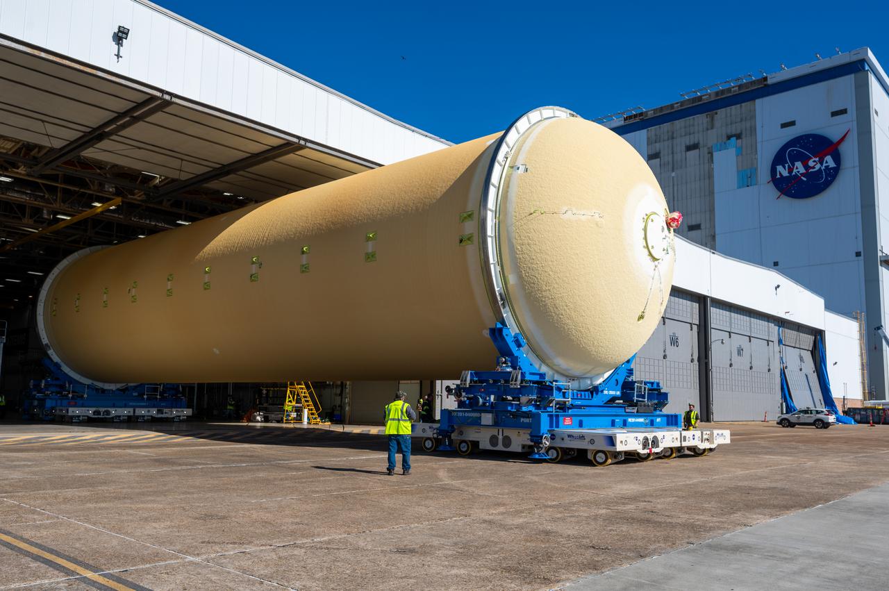 Technicians transported the assembled upper part of the Artemis II core stage to the final assembly area inside the factory at NASA’s Michoud Assembly Facility in New Orleans.  On Jan 10, the forward assembly, left was moved next to the Artemis II liquid hydrogen tank, which has been undergoing assembly. Next, Boeing, the lead core stage contractor, will join the forward assembly and the liquid hydrogen tank to complete most of the core stage for the Space Launch System (SLS) rocket that will send the first crew on an Artemis mission. The core stage consists of five major structures that are built, outfitted, and then connected to form the final stage. The forward skirt, liquid oxygen and intertank were connected and tested to form the 66-foot forward assembly. After the forward assembly is joined with the 130-foot liquid hydrogen tank, only the engine section, the fifth piece of the stage, will need to be added to complete the Artemis II core stage.  The core stage serves as the backbone of the rocket, supporting the weight of the payload, upper stage, and crew vehicle, as well as the thrust of its four RS-25 engines and two five-segment solid rocket boosters attached to the engine and intertank sections. On Artemis II, the SLS rocket will launch the Orion spacecraft and a crew, sending them into lunar orbit, in preparation for later Artemis missions that will enable the first woman and first person of color to land on the Moon.